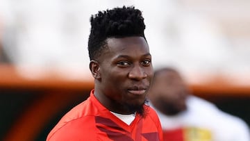 Cameroon's goalkeeper #24 Andre Onana warms up ahead of during the Africa Cup of Nations (CAN) 2024 group C football match between Gambia and Cameroon at Stade de la Paix in Bouake on January 23, 2024. (Photo by KENZO TRIBOUILLARD / AFP)