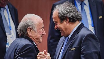 (FILES) This file photo taken on May 29, 2015 shows FIFA President Sepp Blatter (foreground-L) shaking hands with UEFA president Michel Platini after being re-elected following a vote to decide on the FIFA presidency in Zurich on May 29, 2015. Sepp Blatter won the FIFA presidency for a fifth time after his challenger Prince Ali bin al Hussein withdrew just before a scheduled second round. AFP PHOTO / MICHAEL BUHOLZER / AFP PHOTO / Michael BUHOLZER