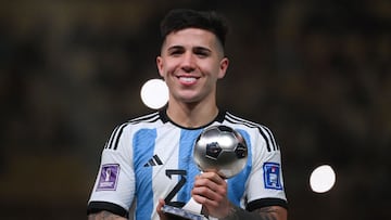 Argentina's midfielder #24 Enzo Fernandez receives the Young Player award during the Qatar 2022 World Cup trophy ceremony after the football final match between Argentina and France at Lusail Stadium in Lusail, north of Doha on December 18, 2022. - Argentina won in the penalty shoot-out. (Photo by FRANCK FIFE / AFP)