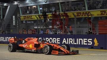 Ferrari&#039;s German driver Sebastian Vettel gestures to his team after winning the Formula One Singapore Grand Prix night race at the Marina Bay Street Circuit in Singapore on September 22, 2019. (Photo by Roslan RAHMAN / AFP)