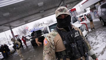 A federal agent of commander Greg Bovino's team looks on during a stop at a gas station, as immigration enforcement continues after a U.S. Immigration and Customs Enforcement (ICE) agent fatally shot Renee Nicole Good on January 7, in Minneapolis, Minnesota, U.S., January 21, 2026. REUTERS/Seth Herald