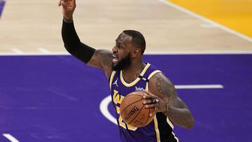 Los Angeles Lakers forward LeBron James directs the offense against the Sacramento Kings during the first half of an NBA basketball game Friday, April 30, 2021, in Los Angeles. (AP Photo/Marcio Jose Sanchez)
