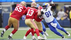 Kobie Turner #91 of the Los Angeles Rams rushes Brock Purdy #13 of the San Francisco 49ers