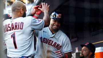 NEW YORK, NEW YORK - OCTOBER 14: Oscar Gonzalez #39 of the Cleveland Guardians celebrates with Amed Rosario #1 in the dugout after scoring a run on a one-run RBI double hit by Josh Naylor #22 (not pictured) during the tenth inning against the New York Yankees in game two of the American League Division Series at Yankee Stadium on October 14, 2022 in New York, New York. (Photo by Sarah Stier/Getty Images)