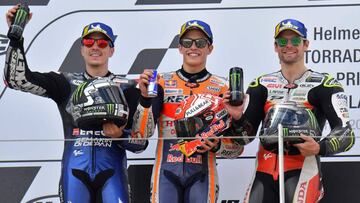 Winner Repsol Honda Team&#039;s Spanish rider Marc Marquez (C), second placed Monster Energy Yamaha&#039; Spanish rider Maverick Vinales and third placed LCR Honda&#039;s British rider Cal Crutchlow (R) celebrate on the podium after winning the Moto GP Grand Prix Germany at the Sachsenring Circuit on July 7, 2019 in Hohenstein-Ernstthal, eastern Germany. (Photo by Tobias SCHWARZ / AFP)