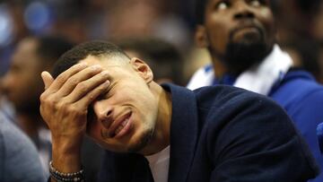 Golden State Warriors Stephen Curry, left, and Kevin Durant look on from the bench as the Warriors play the Dallas Mavericks during the second half of an NBA basketball game, Saturday, Nov. 17, 2018, in Dallas. The Mavericks won 112-109. (AP Photo/Ron Jenkins)