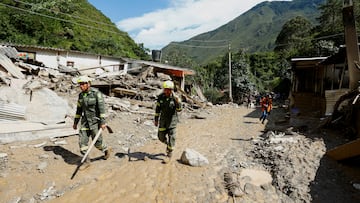 Colombia National Police rescue officers walk at an area affected by a landslide which left several casualties and others injured, in Quetame, Colombia, July 18, 2023. REUTERS/Santiago Molina NO RESALES. NO ARCHIVES