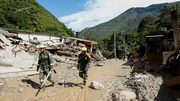 Colombia National Police rescue officers walk at an area affected by a landslide which left several casualties and others injured, in Quetame, Colombia, July 18, 2023. REUTERS/Santiago Molina NO RESALES. NO ARCHIVES