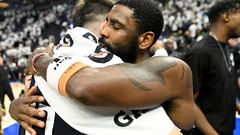 MINNEAPOLIS, MINNESOTA - MAY 22: Kyrie Irving #11 of the Dallas Mavericks hugs Luka Doncic #77 after defeating the Minnesota Timberwolves 108-105 in Game One of the Western Conference Finals at Target Center on May 22, 2024 in Minneapolis, Minnesota. NOTE TO USER: User expressly acknowledges and agrees that, by downloading and or using this photograph, User is consenting to the terms and conditions of the Getty Images License Agreement.   Stephen Maturen/Getty Images/AFP (Photo by Stephen Maturen / GETTY IMAGES NORTH AMERICA / Getty Images via AFP)