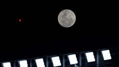 The Sturgeon Moon rises before the start of the Copa Libertadores match between Argentina's River Plate and Brazil's Internacional in Buenos Aires.