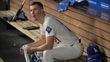 Sep 26, 2024; Los Angeles, California, USA; Los Angeles Dodgers starting pitcher Walker Buehler (21) looks on from the dugout following the second inning against the San Diego Padres at Dodger Stadium. Mandatory Credit: Jayne Kamin-Oncea-Imagn Images
