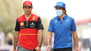 BAHRAIN, BAHRAIN - MARCH 11: Carlos Sainz of Spain and Ferrari and Fernando Alonso of Spain and Alpine F1 walk in the Paddock during Day Two of F1 Testing at Bahrain International Circuit on March 11, 2022 in Bahrain, Bahrain. (Photo by Mark Thompson/Gett