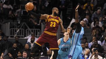 Dec 31, 2016; Charlotte, NC, USA; Cleveland Cavaliers forward LeBron James (23) passes the ball as he is defended by Charlotte Hornets forward Michael Kidd-Gilchrist (14) and forward center Cody Zeller (40) during the second half of the game at the Spectrum Center. Cavaliers win 121-109. Mandatory Credit: Sam Sharpe-USA TODAY Sports