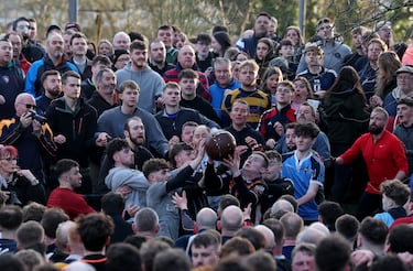 Los jugadores de los equipos Up'ards y Down'ards compiten por el balón durante el partido.