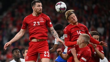 (FILES) In this file photo taken on September 25, 2022 Denmark's midfielder Pierre-Emile Hojbjerg (L) and Denmark's forward Kasper Dolberg both jump to head the ball during the UEFA Nations League football match between Denmark and France in Copenhagen on September 25, 2022.