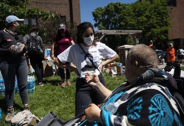 MINNEAPOLIS, MN - MAY 30: People arrange donations at Holy Trinity Lutheran Church on May 30, 2020 in Minneapolis, Minnesota. Buildings and businesses around the Twin Cities have been looted and destroyed in the fallout after the death of George Floyd while in police custody. Police Officer Derek Chauvin has been charged with third-degree murder and manslaughter in Floyd's death. Stephen Maturen/Getty Images/AFP == FOR NEWSPAPERS, INTERNET, TELCOS & TELEVISION USE ONLY ==