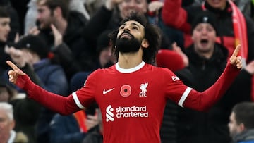 Liverpool's Egyptian striker #11 Mohamed Salah celebrates after scoring the opening goal of the English Premier League football match between Liverpool and Brentford at Anfield in Liverpool, north west England on November 12, 2023. (Photo by Paul ELLIS / AFP) / RESTRICTED TO EDITORIAL USE. No use with unauthorized audio, video, data, fixture lists, club/league logos or 'live' services. Online in-match use limited to 120 images. An additional 40 images may be used in extra time. No video emulation. Social media in-match use limited to 120 images. An additional 40 images may be used in extra time. No use in betting publications, games or single club/league/player publications. / 