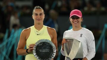 Poland's Iga Swiatek (R) holds her winner's trophy beside runner-up Belarus' Aryna Sabalenka during the 2024 WTA Tour Madrid Open tournament final tennis match at Caja Magica in Madrid on May 4, 2024. (Photo by Pierre-Philippe MARCOU / AFP)