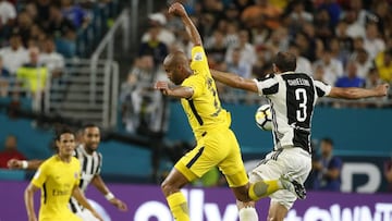The ball eludes Lucas Moura (C) of Paris Saint-Germain and Giorgio Chiellini (R) of Juventus during their International Champions Cup friendly match at Hard Rock Stadium in Miami, Florida, on July 25, 2017. / AFP PHOTO / Rhona Wise