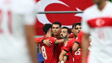 Portugal's midfielder #08 Bruno Fernandes (L) celebrates with Portugal's forward #07 Cristiano Ronaldo (C) and teammates after scoring his team's third goal during the UEFA Euro 2024 Group F football match between Turkey and Portugal at the BVB Stadion in Dortmund on June 22, 2024. (Photo by OZAN KOSE / AFP)