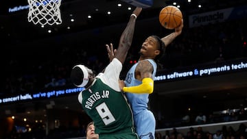 Dec 15, 2022; Memphis, Tennessee, USA; Memphis Grizzlies guard Ja Morant (12) drives to the basket as Milwaukee Bucks forward Bobby Portis (9) defends during the first half at FedExForum. Mandatory Credit: Petre Thomas-USA TODAY Sports