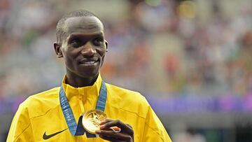 Gold medallist Uganda's Joshua Cheptegei poses on the podium during the medal ceremony for the men's 10000m final of the athletics event at the Paris 2024 Olympic Games at Stade de France in Saint-Denis, north of Paris, on August 3, 2024. (Photo by Martin BERNETTI / AFP)