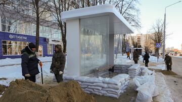 Workers put protective sandbags at a bus stop following recent Ukrainian shelling in Belgorod, Russia, January 12, 2024. REUTERS/Stringer