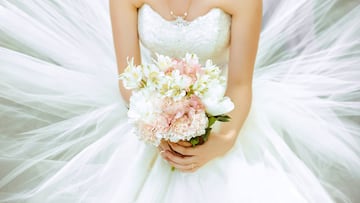 Bouquet of the bride in a magnificent white dress.