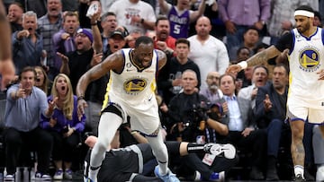 Draymond Green #23 of the Golden State Warriors steps over Domantas Sabonis #10 of the Sacramento Kings in the second half during Game Two of the Western Conference First Round Playoffs at Golden 1 Center on April 17, 2023 in Sacramento, California. Green was issued a flagrant foul 2 on the play, and ejected from the game.