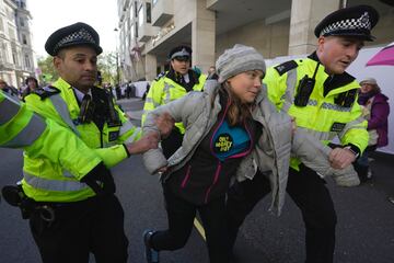 Greta Thumberg es llevada por varios policías duarante la protesta en Londres.