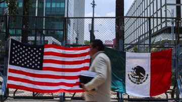 A person passes by Mexican and U.S flags placed outside the U.S. Embassy in Mexico City during a demonstration in support of the L.A. protests, Mexico June 9, 2025. REUTERS/Raquel Cunha