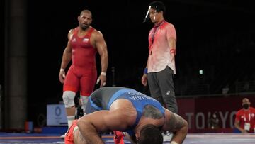 Georgia's Lakobi Kajaia, left, gestures after winning against Chile's Yasmani Acosta Fernandez during the semi-final round of men's 130kg Greco-Roman wrestling match at the 2020 Summer Olympics, Sunday, Aug. 1, 2021, in Chiba, Japan. (AP Photo/Aaron Favila)