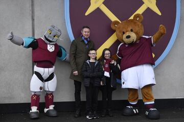 Soccer Football - Premier League - West Ham United v Southampton - London Stadium, London, Britain - December 26, 2021 West Ham United fans pose outside the stadium with mascots before the match