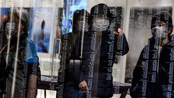 Visitors wearing face masks, amid concerns over the spread of the COVID-19 novel coronavirus, visit the Japan Olympic Museum in Tokyo on February 26, 2020. (Photo by Philip FONG / AFP)