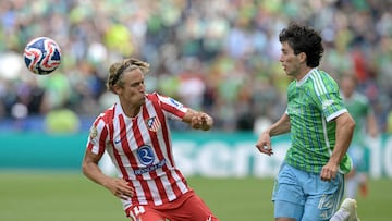 Atletico Madrid's Spanish midfielder #14 Marcos Llorente and Seattle Sounders' US forward #14 Paul Rothrock fight for the ball during the FIFA Club World Cup 2025 Group B football match between US Seattle Sounders and Spain's Atletico de Madrid at the Lumen Field stadium in Seattle on June 19, 2025. (Photo by JUAN MABROMATA / AFP)