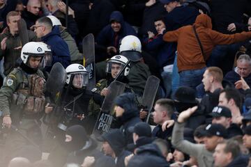 AEK Athens fans jumped onto the pitch and launched flares at the Ajax fans in the Champions League game in Greece on Tuesday night, causing police to intervene.