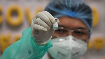 A medical staff shows the Sinopharm vaccine from China during the first day vaccination against the Covid-19 coronavirus at Calmette hospital in Phnom Penh on February 10, 2021. (Photo by TANG CHHIN Sothy / AFP)