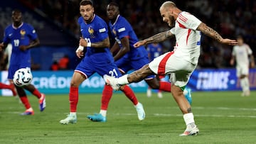 Italy's defender #03 Federico Dimarco kicks the ball and scores during the UEFA Nations League Group A2 football match between France and Italy at the Parc des Princes in Paris on September 6, 2024. (Photo by Franck FIFE / AFP)