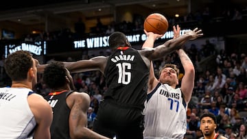 Dec 29, 2022; Dallas, Texas, USA; Dallas Mavericks guard Luka Doncic (77) attempts to shoot over Houston Rockets forward Usman Garuba (16) during the second half at the American Airlines Center. Mandatory Credit: Jerome Miron-USA TODAY Sports