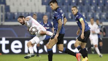 Real Madrid's Isco, left, fights for the ball with Atalanta's Cristian Romero during the Champions League, round of 16, first leg soccer match between Atlanta and Real Madrid, at the Gewiss Stadium in Bergamo, Wednesday, Feb. 24, 2021. (AP Photo/Luca Brun