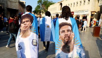 Soccer Football - FIFA World Cup Qatar 2022 - Fans in Souq Waqif - Doha, Qatar - December 13, 2022 Argentina fans with flags of Lionel Messi and Diego Maradona ahead of the semi final Argentina v Croatia REUTERS/Bernadett Szabo