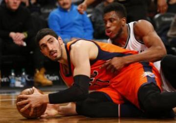 Jan 24, 2016; Brooklyn, NY, USA; Oklahoma City Thunder center Enes Kanter (11) battles Brooklyn Nets forward Thaddeus Young (30) for a loose ball during second half at Barclays Center. The Nets defeated the Thunder  116-106. Mandatory Credit: Noah K. Murray-USA TODAY Sports