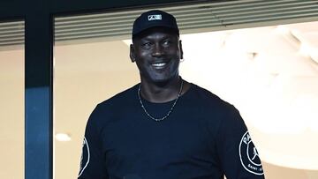 US former  basketball Michael Jordan stands in the tribunes before the  French L1 football match between Paris Saint Germain (PSG) and Reims (SR) on September 26, 2018, at the Parc des Princes stadium in Paris. (Photo by Anne-Christine POUJOULAT / AFP)