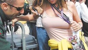 <b>¡Le firmaría en la otra, suponemos!</b> El hombre pelado es Tony Kanaan, piloto brasileño de Fórmula Indy. Ella, no sabemos. ¡Y qué más da! La foto pide una sola apostilla: en aras de la igualdad tetil, le firmaría en la otra, claro. ¡Que hemos luchado mucho por la igualdad!