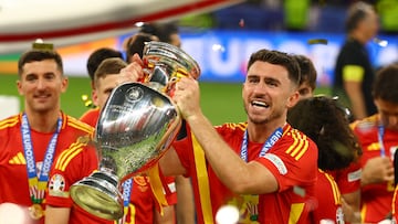 Soccer Football - Euro 2024 - Final - Spain v England - Berlin Olympiastadion, Berlin, Germany - July 14, 2024 Spain's Aymeric Laporte holds aloft the trophy as they celebrate after victory REUTERS/Kai Pfaffenbach