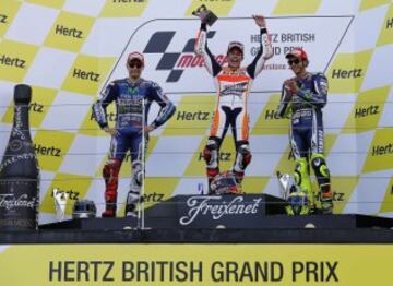 Honda MotoGP rider Marc Marquez (C) of Spain celebrates winning the British Grand Prix with second placed Yamaha rider Jorge Lorenzo of Spain (L) and third placed Yamaha rider Valentino Rossi of Italy at the Silverstone Race Circuit, central England, August 31, 2014. REUTERS/Darren Staples (BRITAIN - Tags: SPORT MOTORSPORT)
