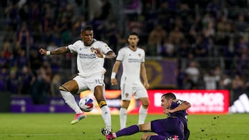 Apr 29, 2023; Orlando, Florida, USA; Orlando City SC defender Kyle Smith (24) tackles the ball away from Los Angeles Galaxy midfielder Douglas Costa (10) in the first half at Exploria Stadium. Mandatory Credit: Morgan Tencza-USA TODAY Sports