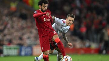 Benfica&#039;s Spanish defender Alex Grimaldo (R) fights for the ball with Liverpool&#039;s Egyptian midfielder Mohamed Salah during the UEFA Champions League quarter final second leg football match between Liverpool and Benfica at the Anfield stadium, in