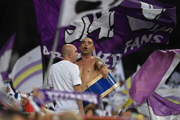 A Real Madrid fan plays with a drum 