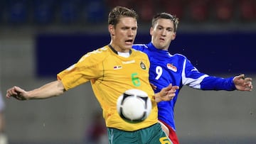 Lithuania's Marius Zaliukas (front) fights for the ball with Liechtenstein's Thomas Beck during their World Cup 2014 qualifying soccer match in Vaduz October 12, 2012. REUTERS/Miro Kuzmanovic (LIECHTENSTEIN - Tags: SPORT SOCCER)